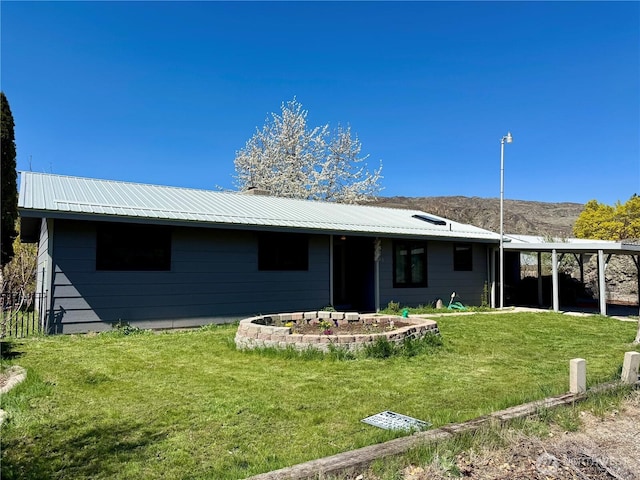 view of front of home featuring a front yard and metal roof