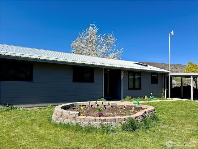 view of front of house with a front yard and metal roof