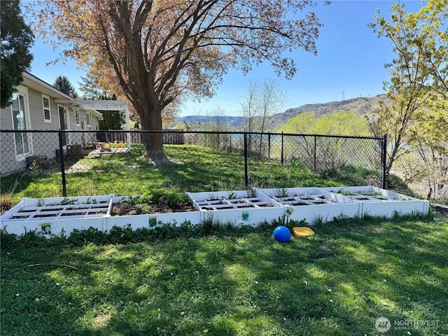 view of yard with fence and a vegetable garden