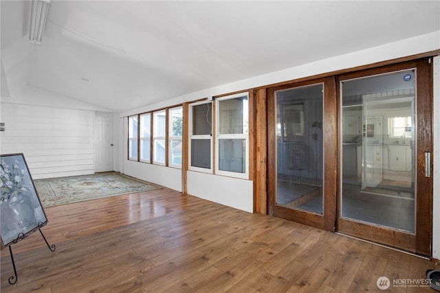 unfurnished sunroom with lofted ceiling