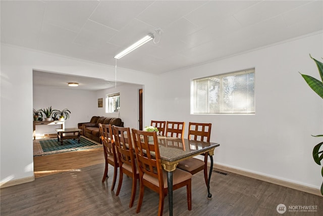 dining space with dark wood-style floors and baseboards