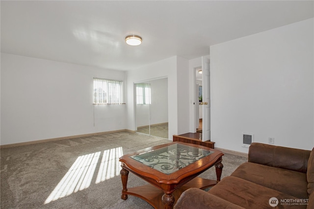 carpeted living room featuring visible vents and baseboards