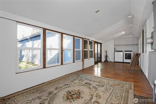 living room with dark wood-type flooring, lofted ceiling, and washer / clothes dryer