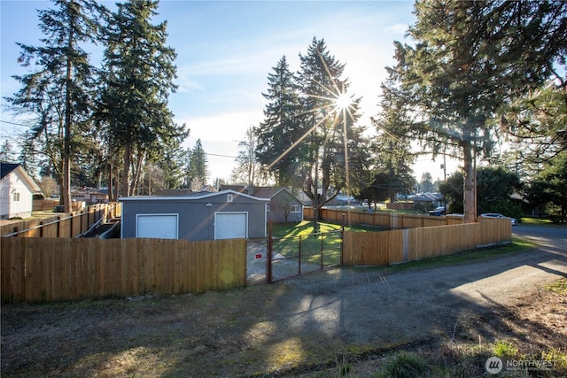 view of yard featuring a garage and fence