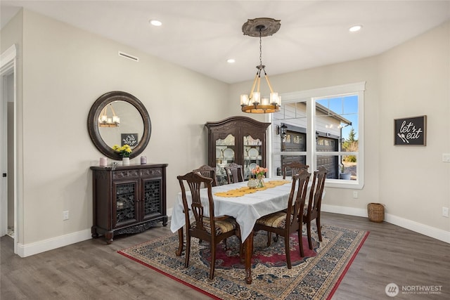 dining space with recessed lighting, dark wood-style flooring, baseboards, and an inviting chandelier