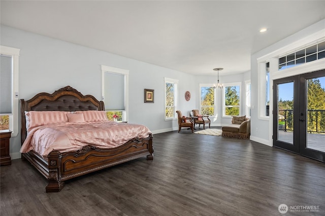 bedroom featuring a notable chandelier, dark wood-type flooring, baseboards, access to exterior, and french doors