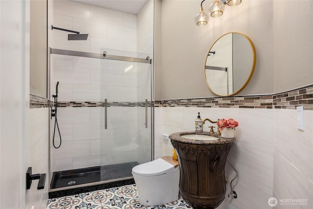 bathroom featuring toilet, vanity, a shower stall, and tile walls