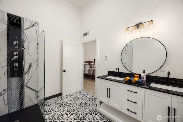 bathroom with double vanity, ensuite bath, visible vents, and a sink