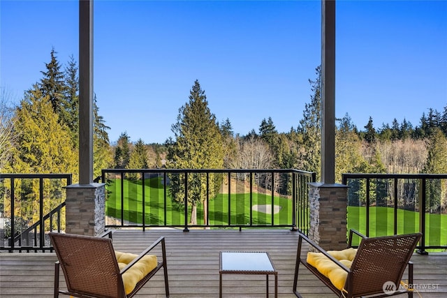 wooden deck featuring a yard