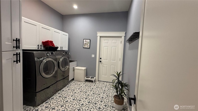 laundry room featuring light tile patterned flooring, independent washer and dryer, and cabinet space