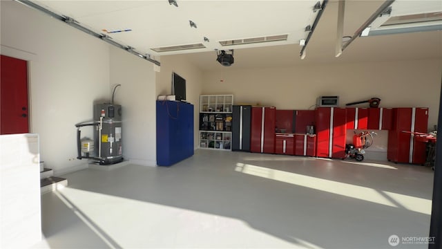 garage with a garage door opener and heat pump water heater