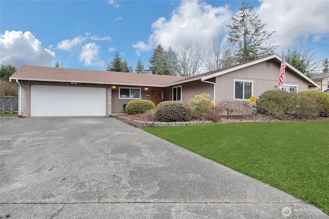 ranch-style house featuring aphalt driveway, a front yard, roof with shingles, and a garage