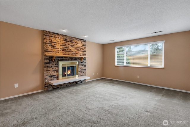 unfurnished living room featuring carpet floors, a brick fireplace, visible vents, and baseboards