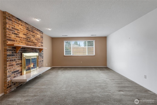 unfurnished living room with a textured ceiling, carpet floors, a fireplace, and baseboards