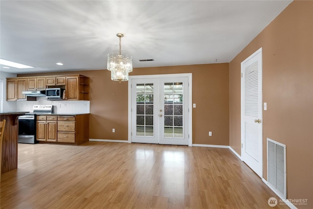 kitchen with stainless steel appliances, brown cabinets, visible vents, and open shelves