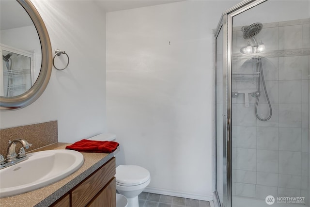 full bath featuring vanity, a shower stall, and toilet