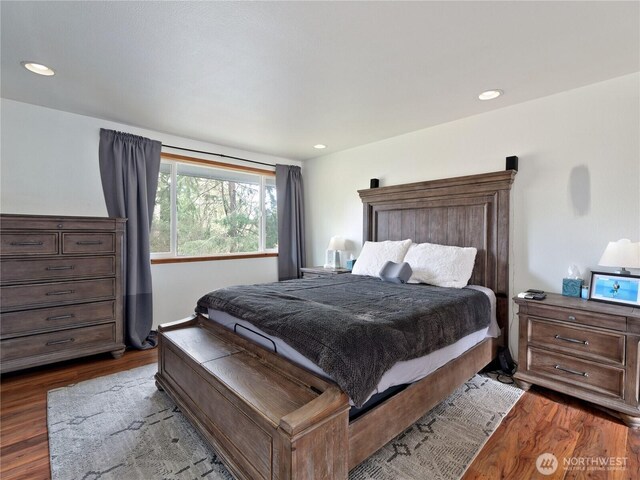 bedroom featuring dark wood-type flooring and recessed lighting