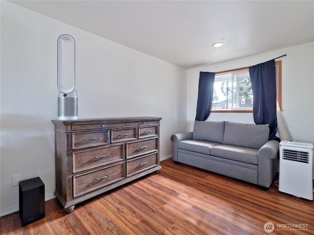 living area featuring baseboards, wood finished floors, and recessed lighting