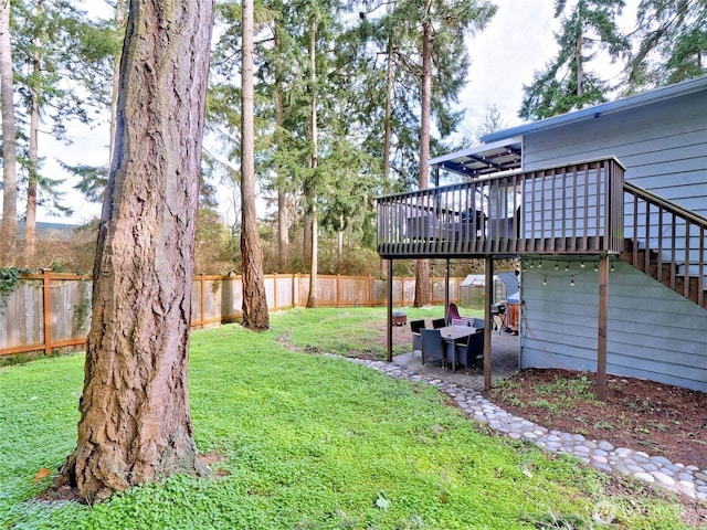 view of yard with stairs, a patio, a fenced backyard, and a wooden deck