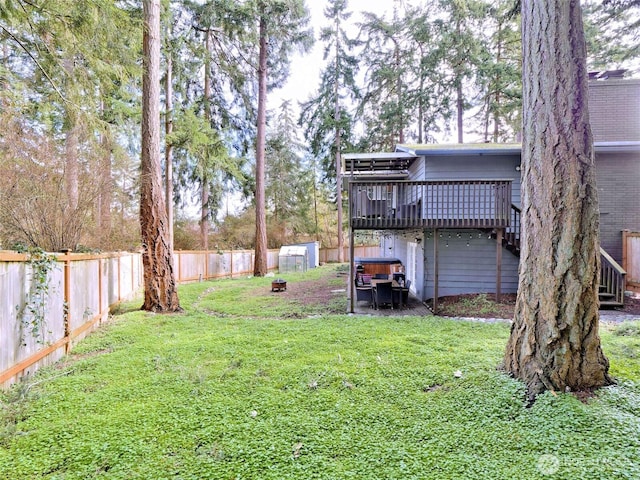 view of yard featuring a deck and a fenced backyard