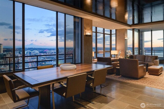 2125 1st Ave Unit 3202, Seattle, WA 98121 - dining room featuring expansive windows, tile patterned flooring, and a water view