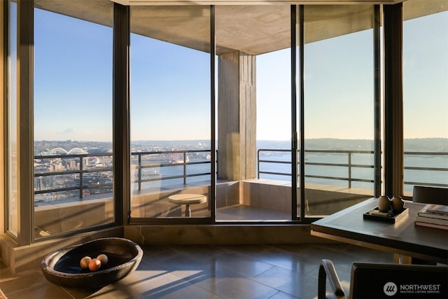 unfurnished sunroom featuring a water view