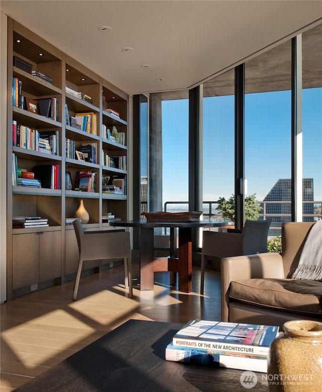 interior space featuring expansive windows and wood finished floors