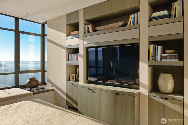 unfurnished bedroom featuring a wall of windows