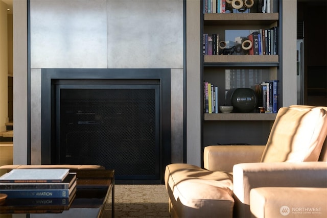 living area featuring a fireplace and built in features