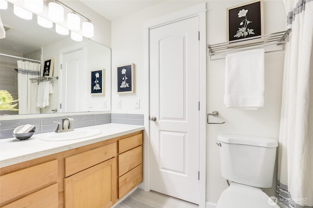 full bath with toilet and vanity