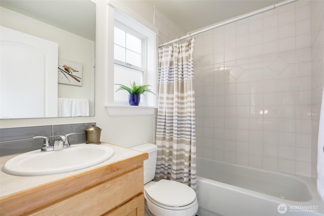 full bath featuring toilet, shower / bathtub combination with curtain, and vanity