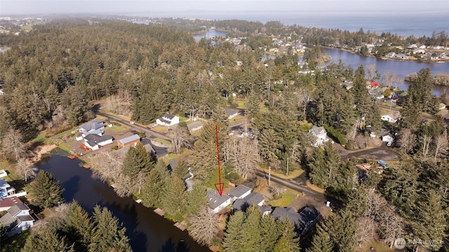 aerial view with a water view and a wooded view