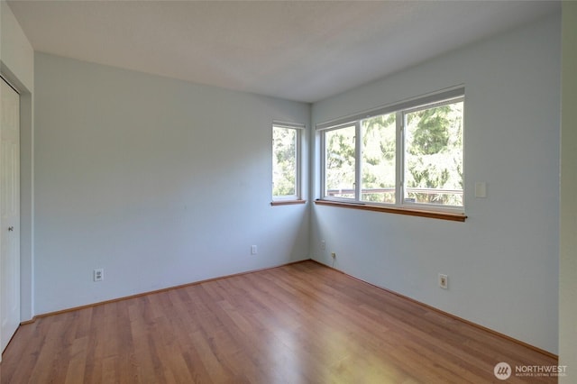 unfurnished room with wood finished floors