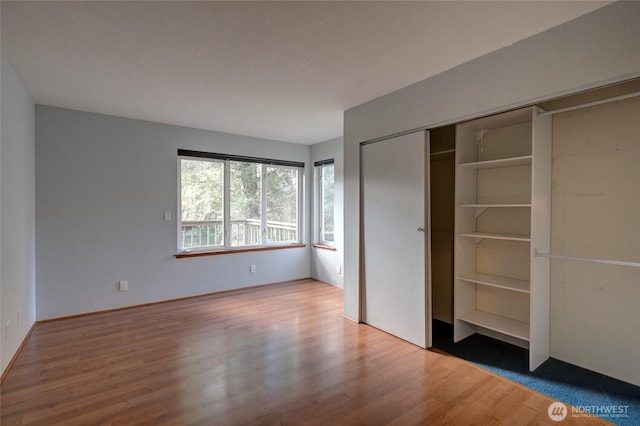 unfurnished bedroom featuring a closet and wood finished floors