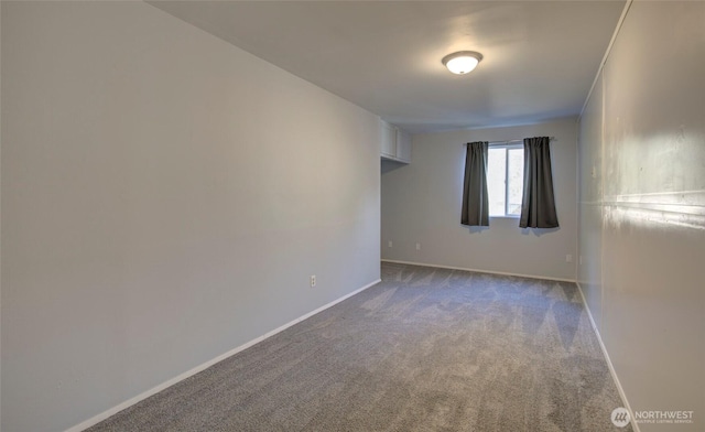 carpeted spare room with baseboards