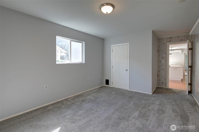 unfurnished bedroom featuring carpet floors and baseboards