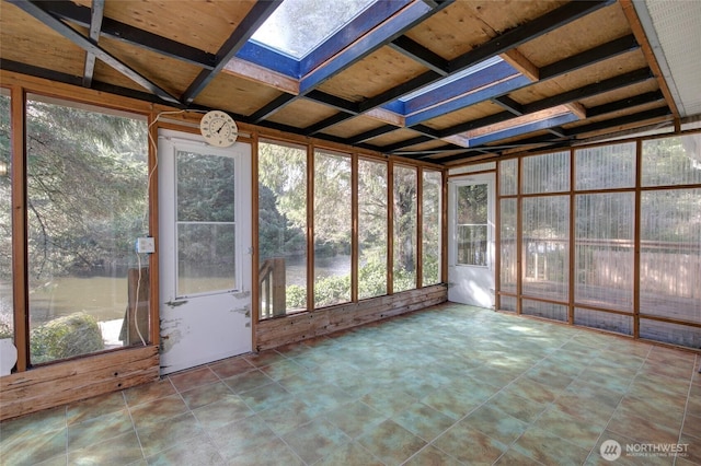 unfurnished sunroom featuring a skylight