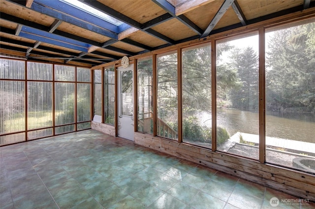 unfurnished sunroom with a water view