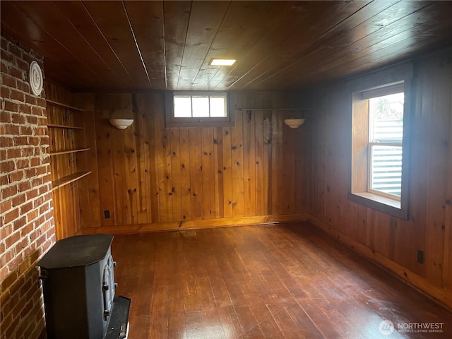 basement with dark wood finished floors, wood ceiling, and wooden walls