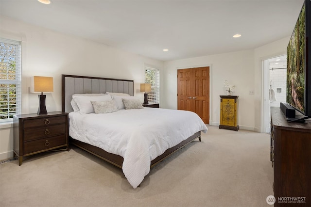 bedroom with recessed lighting, light colored carpet, baseboards, and a closet