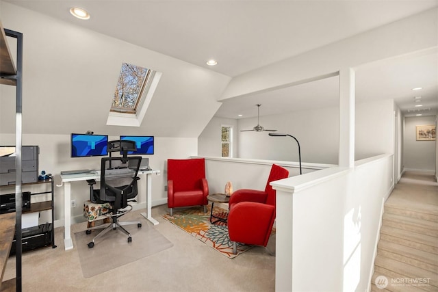 office space featuring recessed lighting, vaulted ceiling with skylight, and baseboards