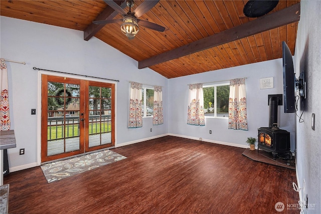 unfurnished living room featuring wood finished floors, baseboards, a wood stove, vaulted ceiling with beams, and french doors