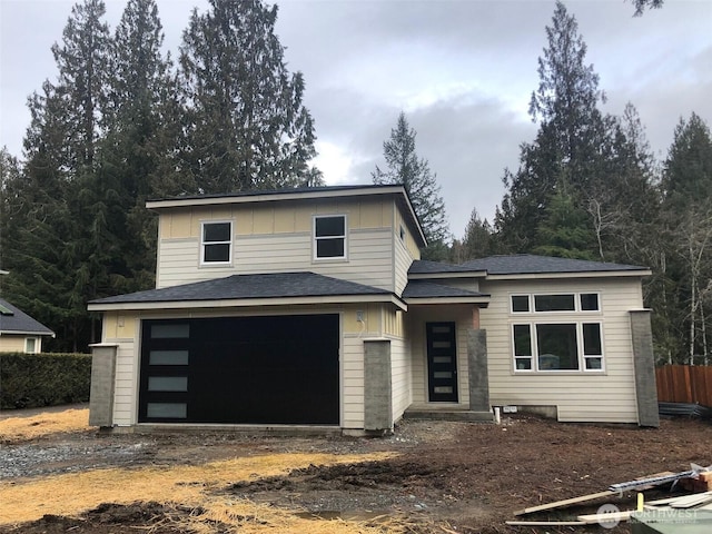 view of front of house featuring an attached garage, fence, board and batten siding, and dirt driveway