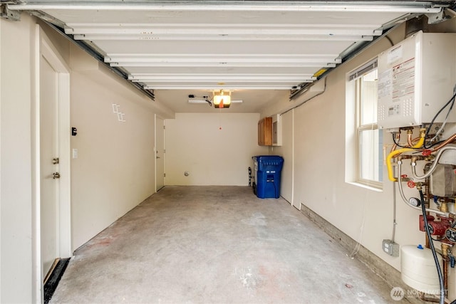 garage featuring water heater and a garage door opener