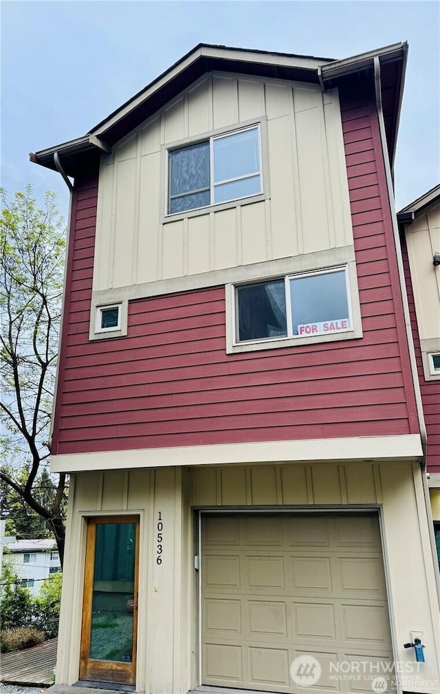 view of property exterior featuring board and batten siding and an attached garage