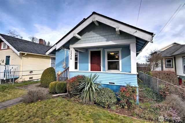 view of front of house featuring a porch, crawl space, a front yard, and fence