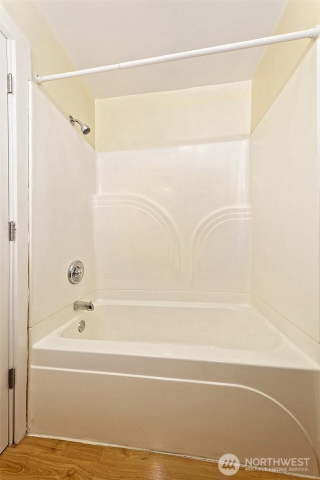 bathroom featuring shower / bathing tub combination and wood finished floors