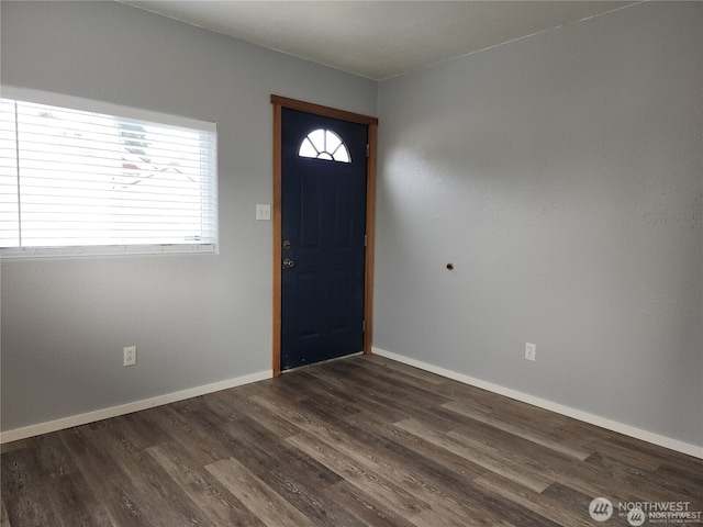 entrance foyer featuring dark wood-type flooring and baseboards