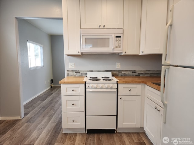 kitchen featuring white appliances, white cabinets, and wood counters