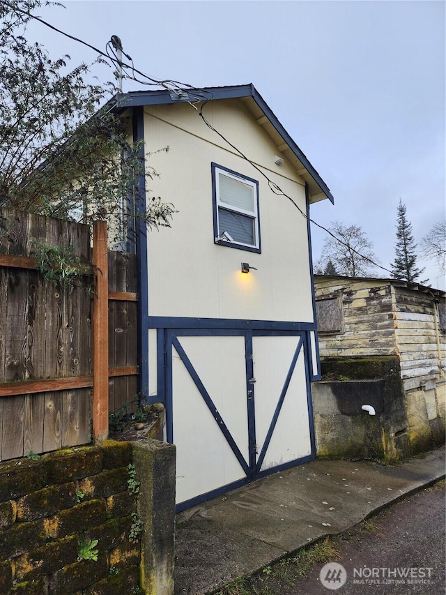 view of outbuilding with fence